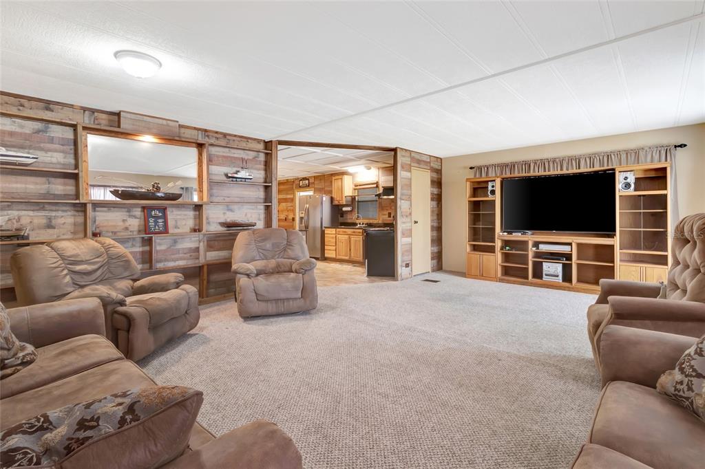 1409 Ridge Road Tavares, FL 32778 - Photo 13 of 36 a living room with furniture and a flat screen tv