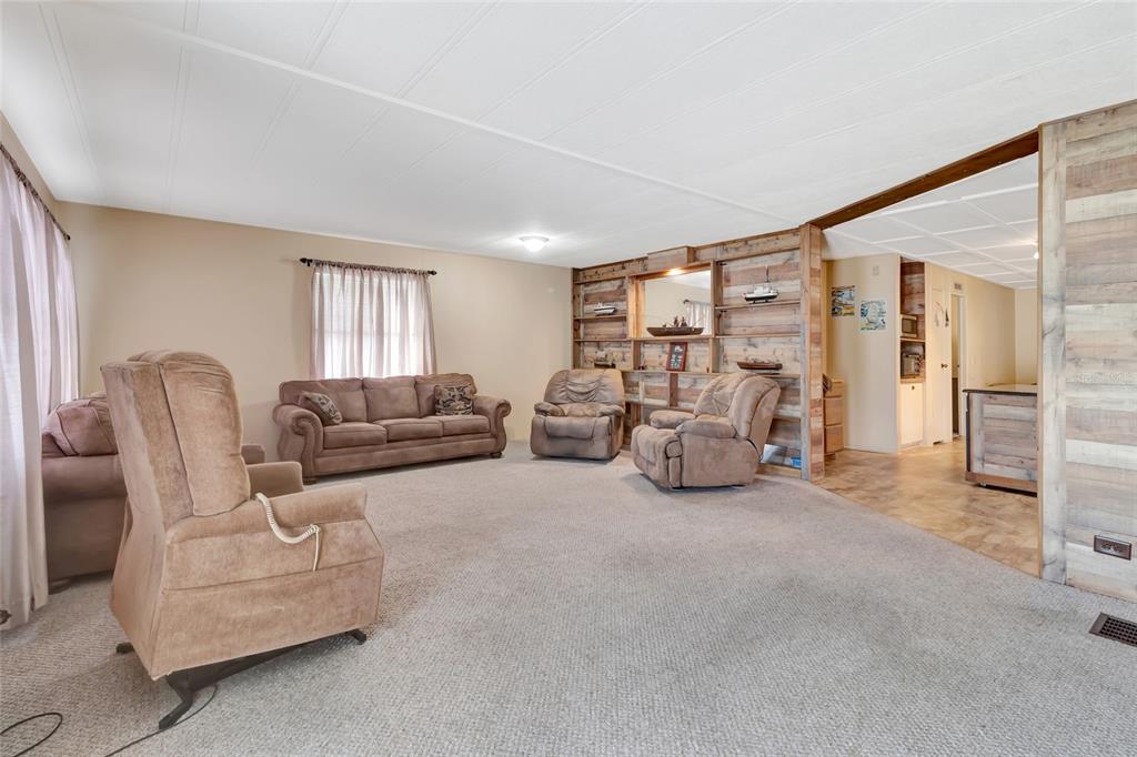 1409 Ridge Road Tavares, FL 32778 - Photo 14 of 36 a living room with furniture and a large window