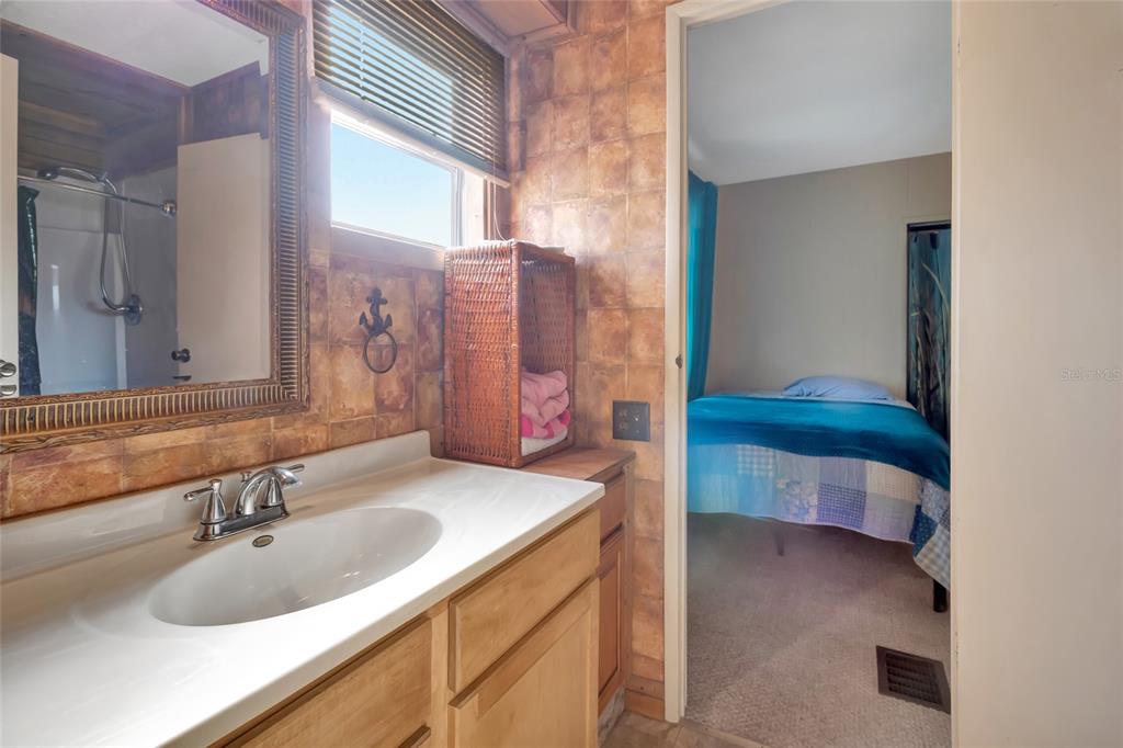 1409 Ridge Road Tavares, FL 32778 - Photo 16 of 36 a bathroom with a sink and a mirror