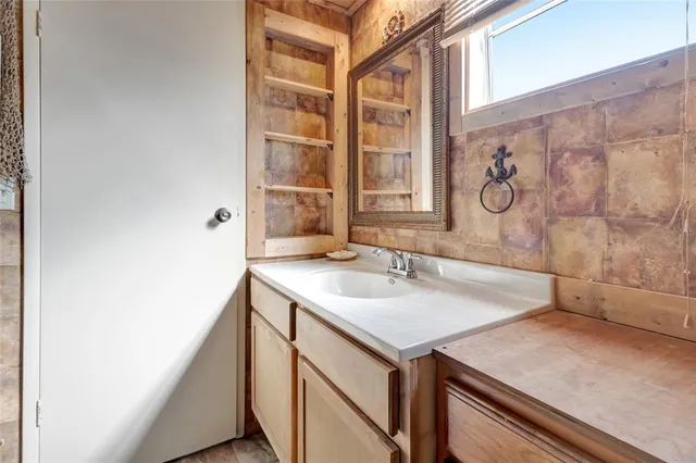 a bathroom with a sink and a mirror