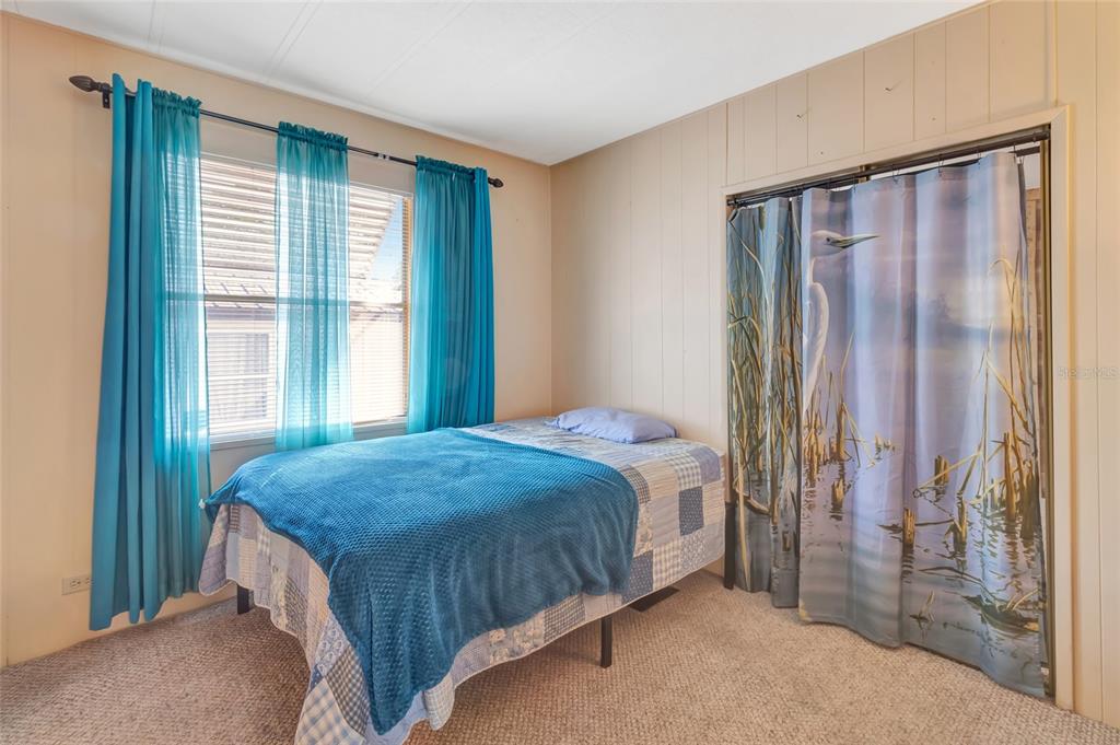 1409 Ridge Road Tavares, FL 32778 - Photo 19 of 36 a bedroom with a bed and a window