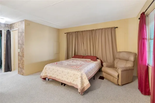 a spacious bedroom with a bed and a couch