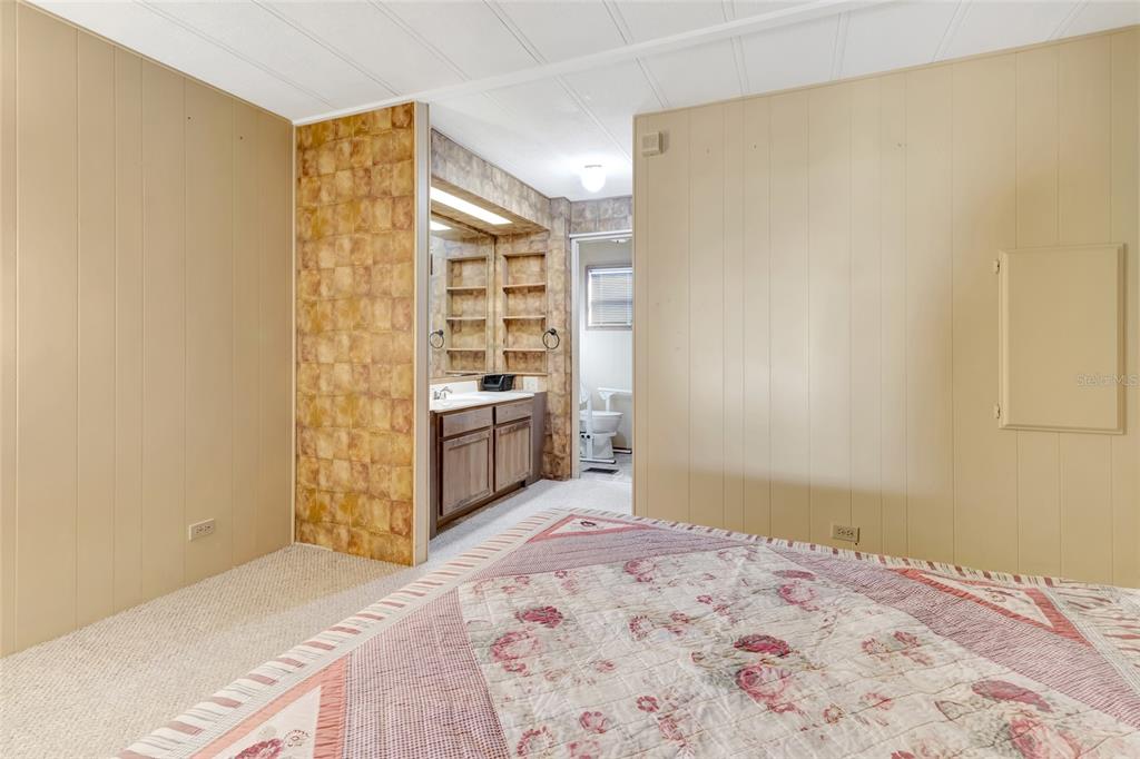 1409 Ridge Road Tavares, FL 32778 - Photo 25 of 36 a bedroom with a bed and a cabinets