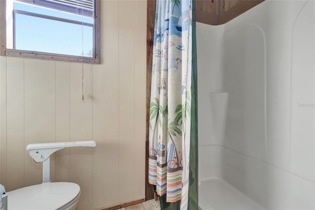 1409 Ridge Road Tavares, FL 32778 - Photo 27 of 36 a bathroom with a shower and toilet