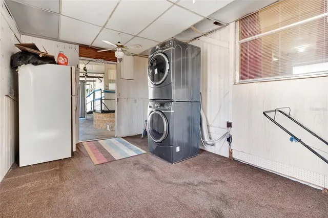 a view of a porch with couches chairs and wooden floor