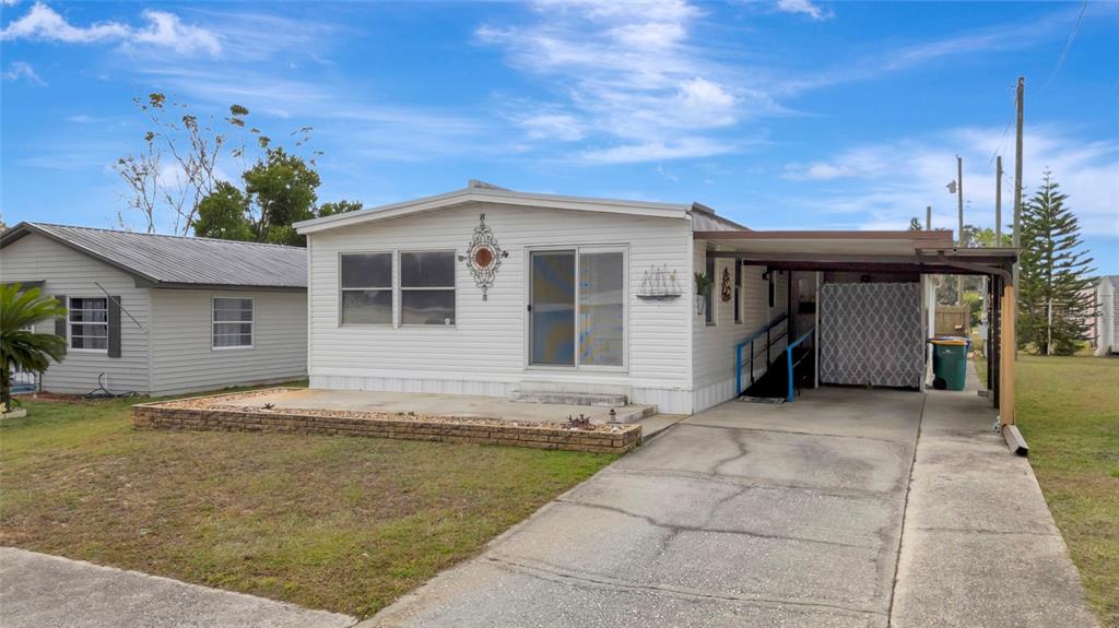 1409 Ridge Road Tavares, FL 32778 - Photo 4 of 36 a front view of a house with a yard