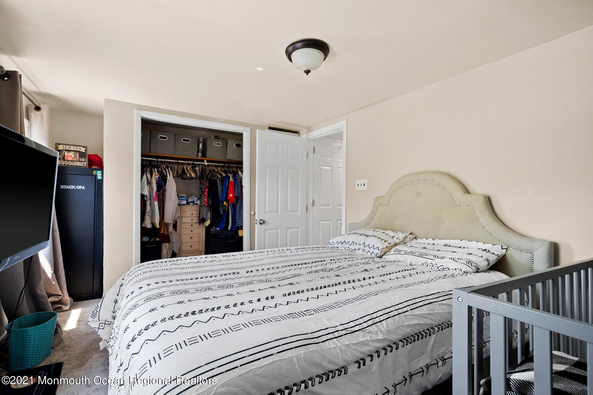 2477 Monmouth Road Jobstown, NJ 08041 - Photo 26 of 37 a bedroom with a bed and a flat tv screen on the dresser