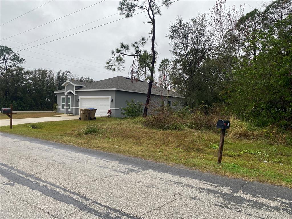Clermont Drive Kissimmee, FL 34759 - Photo 6 of 6 a view of a house with a yard and large tree
