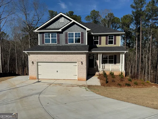 a view of a house with a yard and garage
