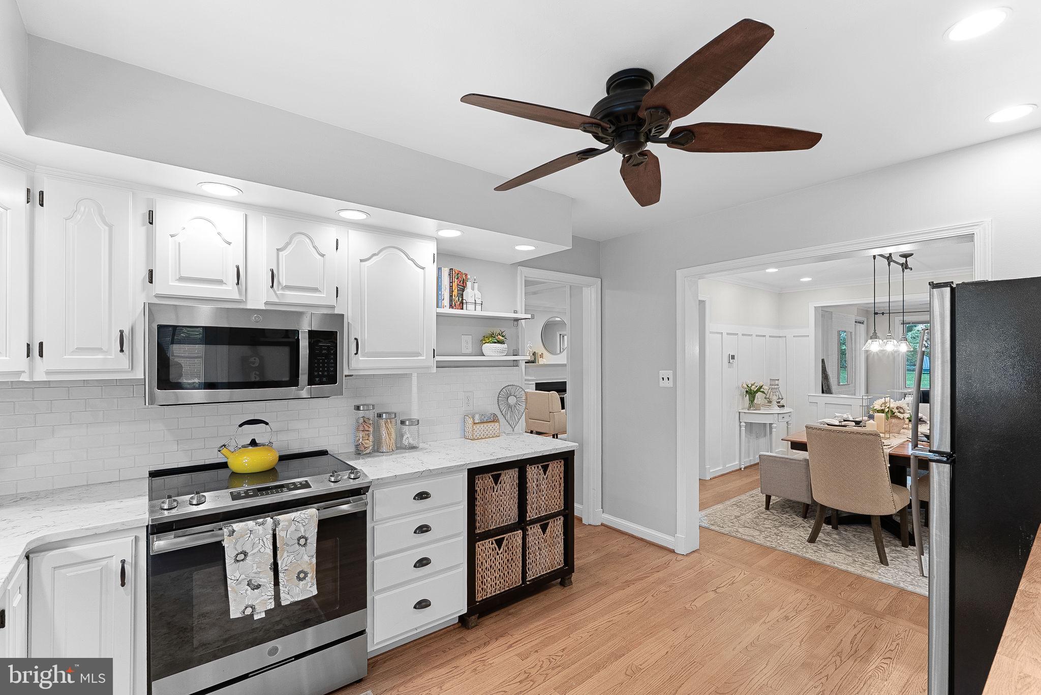 8707 Ridge Road Bethesda, MD 20817 - Photo 18 of 70 a kitchen with stainless steel appliances a stove a sink and a refrigerator