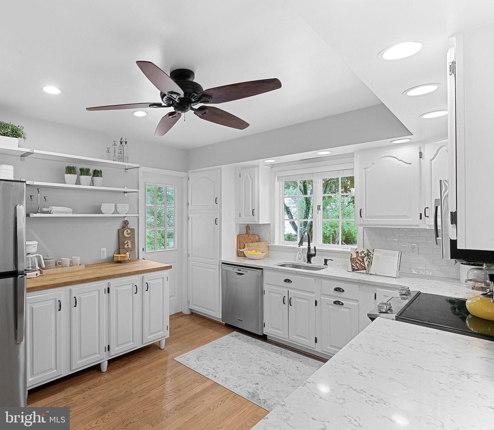 8707 Ridge Road Bethesda, MD 20817 - Photo 19 of 70 a kitchen with a sink window and cabinets