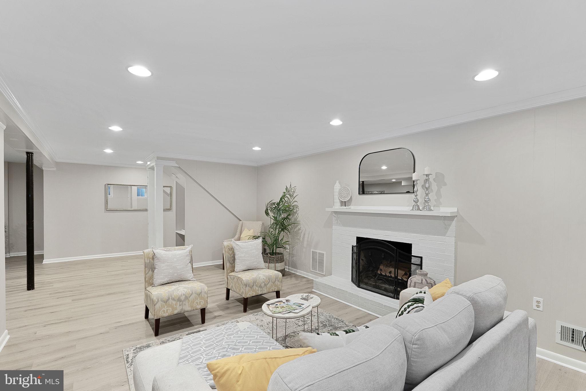8707 Ridge Road Bethesda, MD 20817 - Photo 28 of 70 a living room with furniture and a fireplace