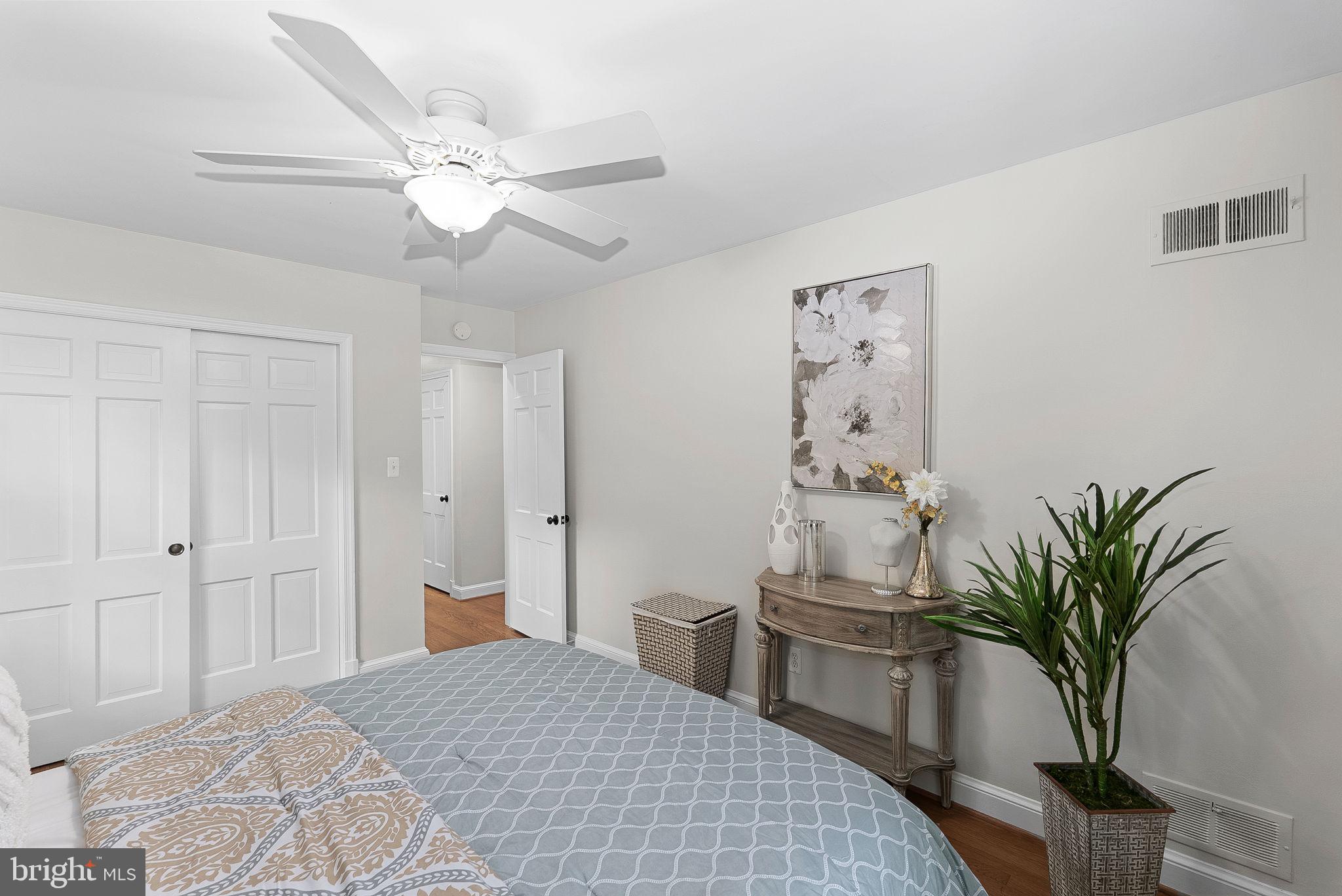 8707 Ridge Road Bethesda, MD 20817 - Photo 36 of 70 a bedroom with a large bed and a chandelier