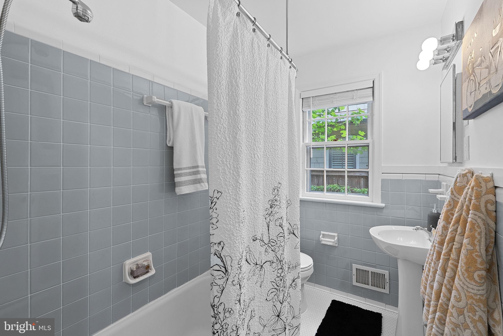 8707 Ridge Road Bethesda, MD 20817 - Photo 53 of 70 a bathroom with a shower curtain and a window