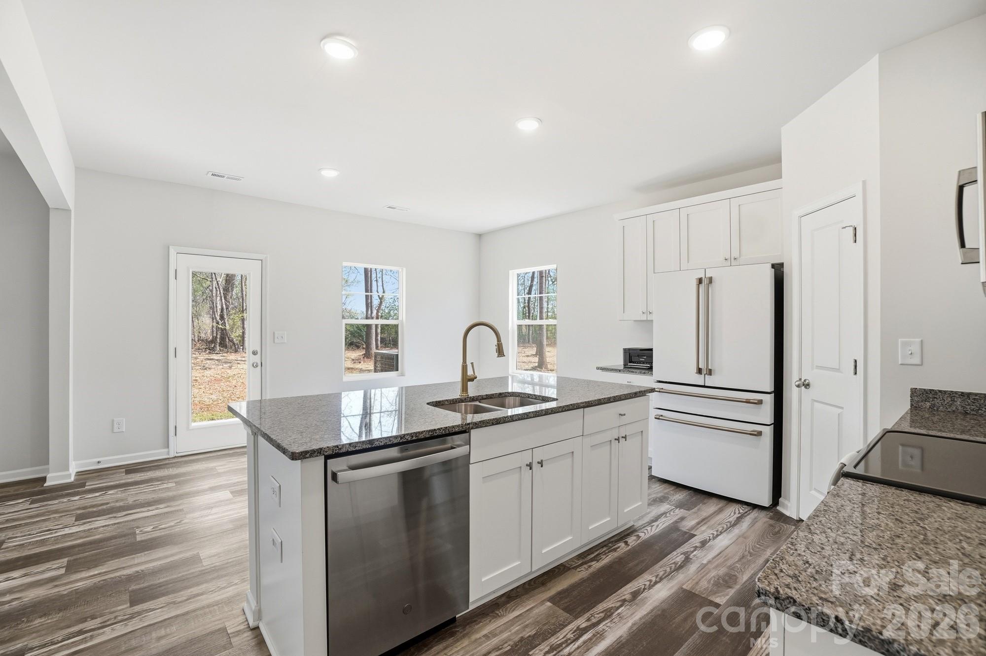 3248 Killian Road Lincolnton, NC 28092 - Photo 13 of 44 a kitchen with white cabinets and sink