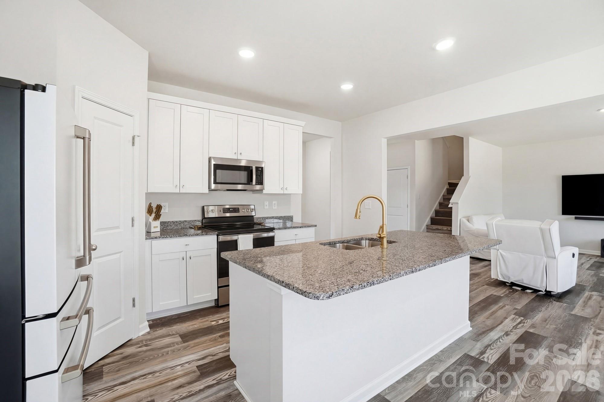 3248 Killian Road Lincolnton, NC 28092 - Photo 14 of 44 a kitchen with granite countertop a sink and a stove top oven