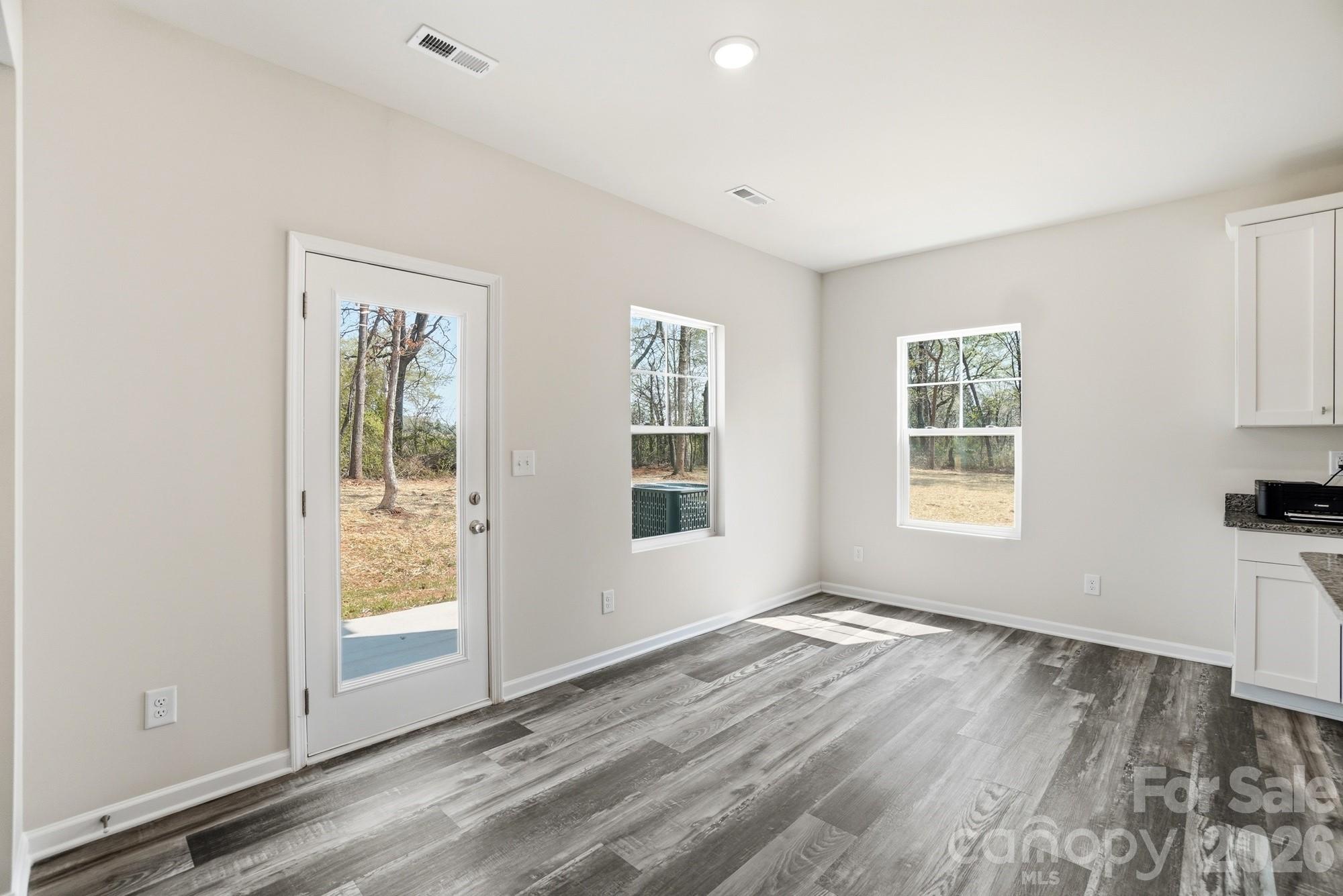 3248 Killian Road Lincolnton, NC 28092 - Photo 17 of 44 an empty room with wooden floor and windows