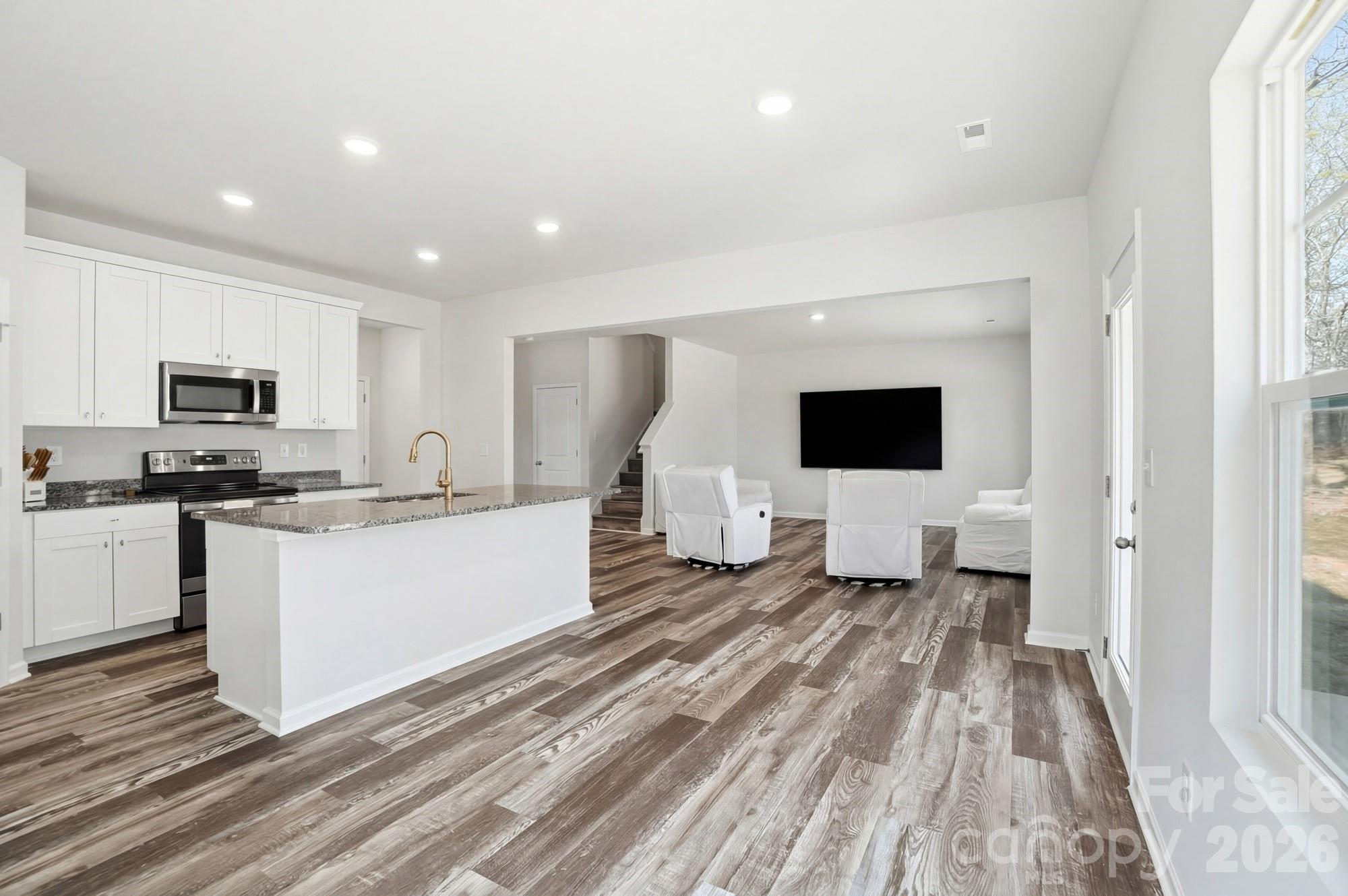3248 Killian Road Lincolnton, NC 28092 - Photo 18 of 44 a living room with stainless steel appliances kitchen island granite countertop furniture a rug and a window
