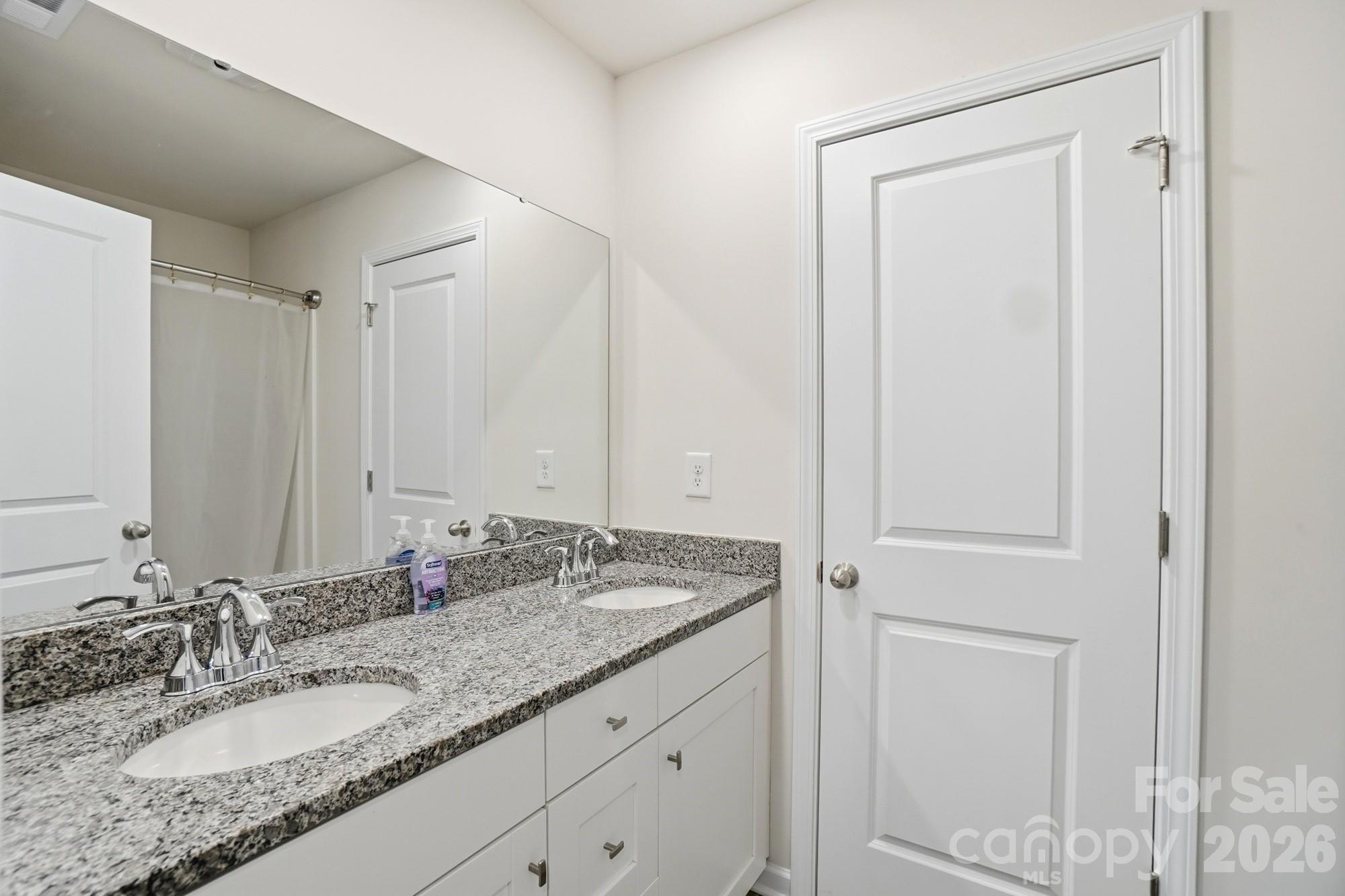 3248 Killian Road Lincolnton, NC 28092 - Photo 34 of 44 a bathroom with a granite countertop sink and a mirror