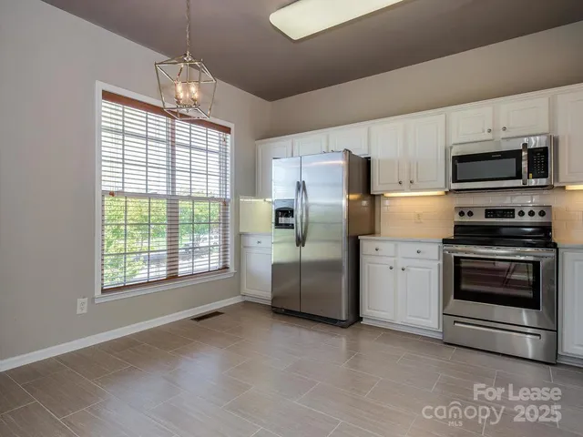 a kitchen with stainless steel appliances a stove sink and refrigerator