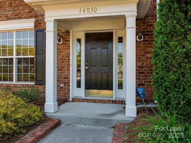 a couple of potted plants in front of door