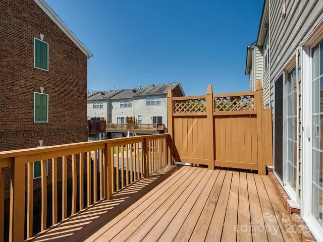 a view of a wooden chairs on a balcony