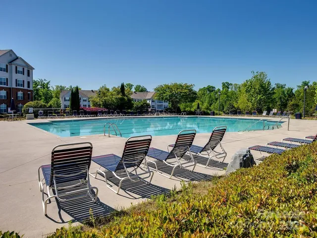 a view of a swimming pool and lounge chairs