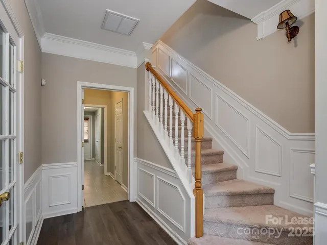 a view of entryway and hall with wooden floor