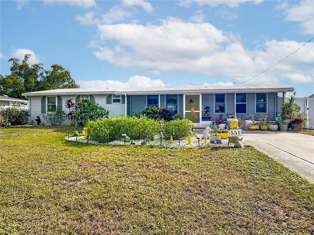 a view of a house with backyard sitting area and garden