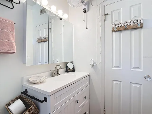 a bathroom with a sink a vanity and a mirror