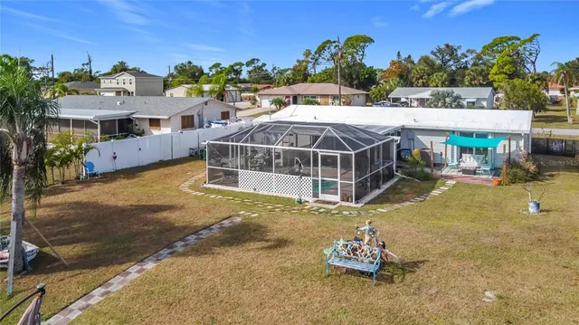 a view of a house with a yard and sitting area
