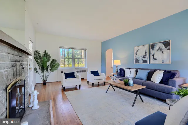 a dining room with wooden floor a chandelier a wooden table and chairs