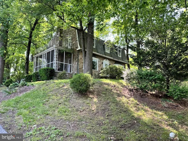 a view of a house with a yard and tree s