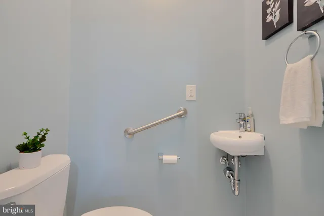 a living room with furniture a ceiling fan and a rug