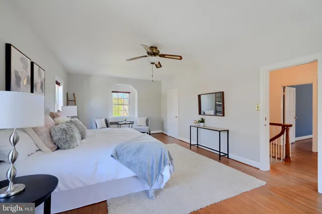 a living room with furniture a air conditioner and a window
