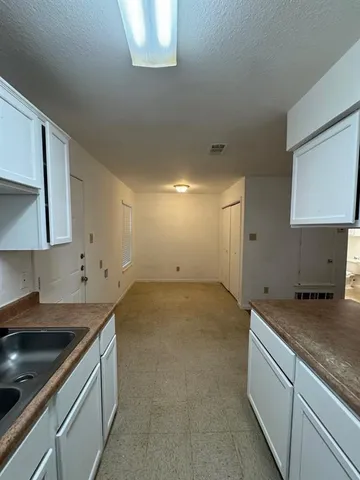 a stove top oven sitting inside of a kitchen
