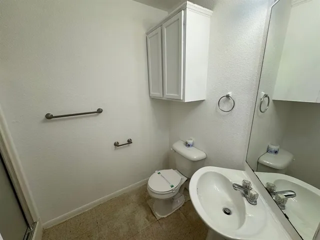 a bathroom with a glass shower door