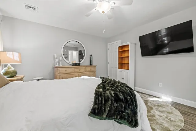 a bedroom with a bed and a flat screen tv