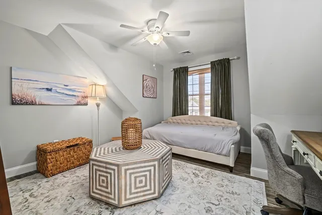 a bedroom with furniture and wooden floor