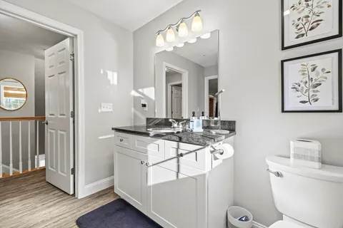 a bathroom with a toilet a sink and a mirror