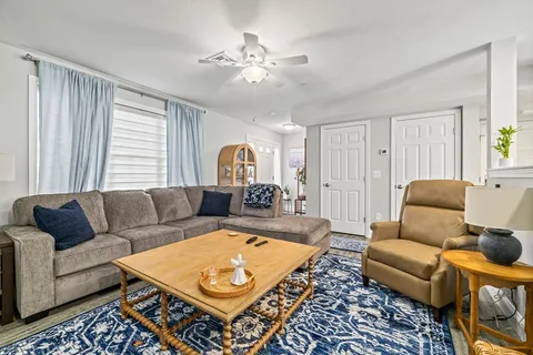 a living room with furniture and a rug
