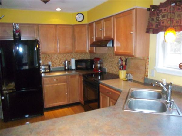 4 Circle Street Middleton, MA 01949 - Photo 4 of 19 a kitchen with stainless steel appliances granite countertop a sink a stove and a refrigerator