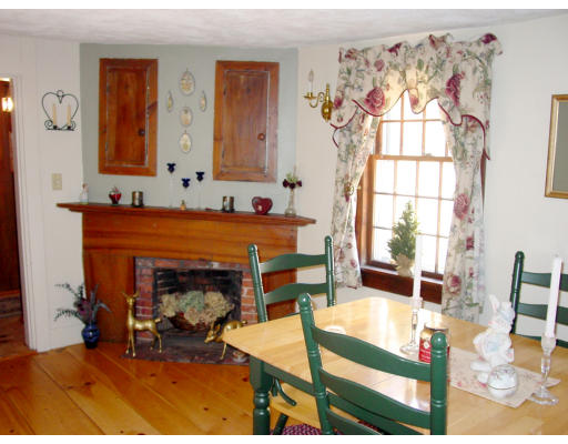 208 Great Road Stow, MA 01775 - Photo 4 of 9 a living room with furniture a flat screen tv and a fireplace