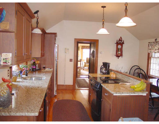 208 Great Road Stow, MA 01775 - Photo 5 of 9 a kitchen with sink a refrigerator and a flat screen tv