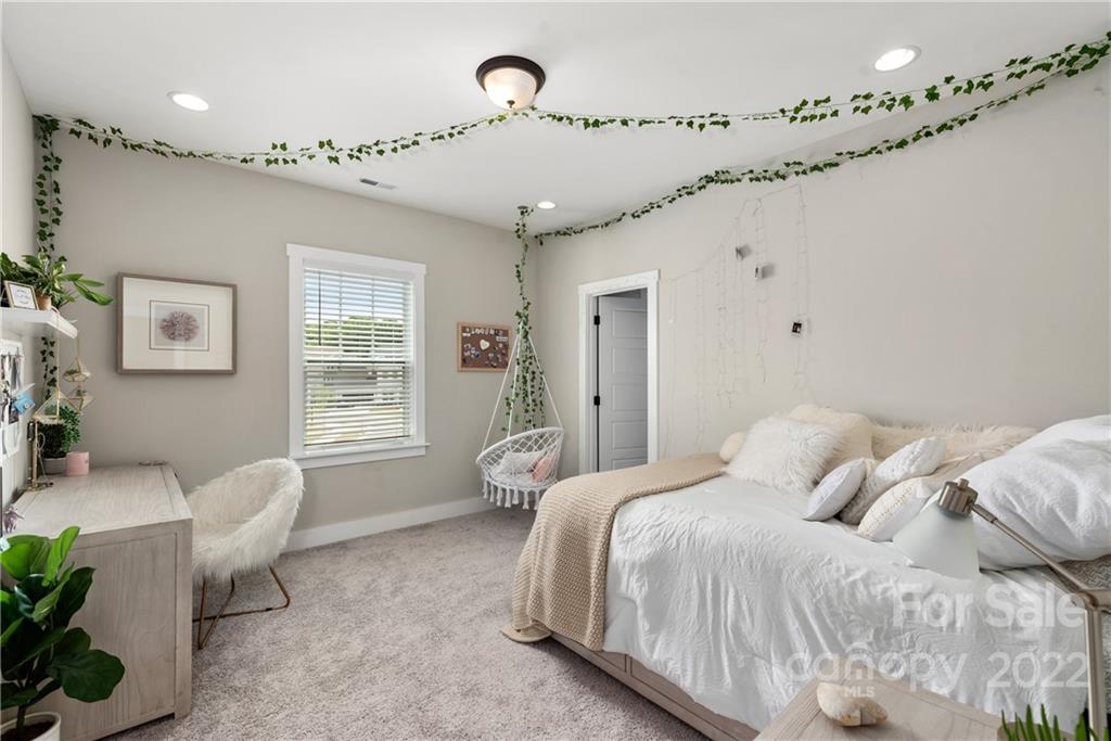 513 Small Batch Path Fort Mill, SC 29708 - Photo 30 of 48 a bedroom with a bed couch and window