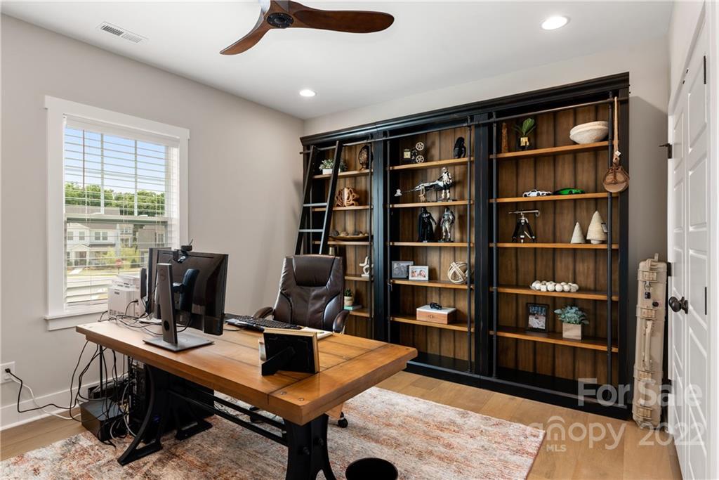 513 Small Batch Path Fort Mill, SC 29708 - Photo 35 of 48 a view of a workspace with furniture and a bookshelf