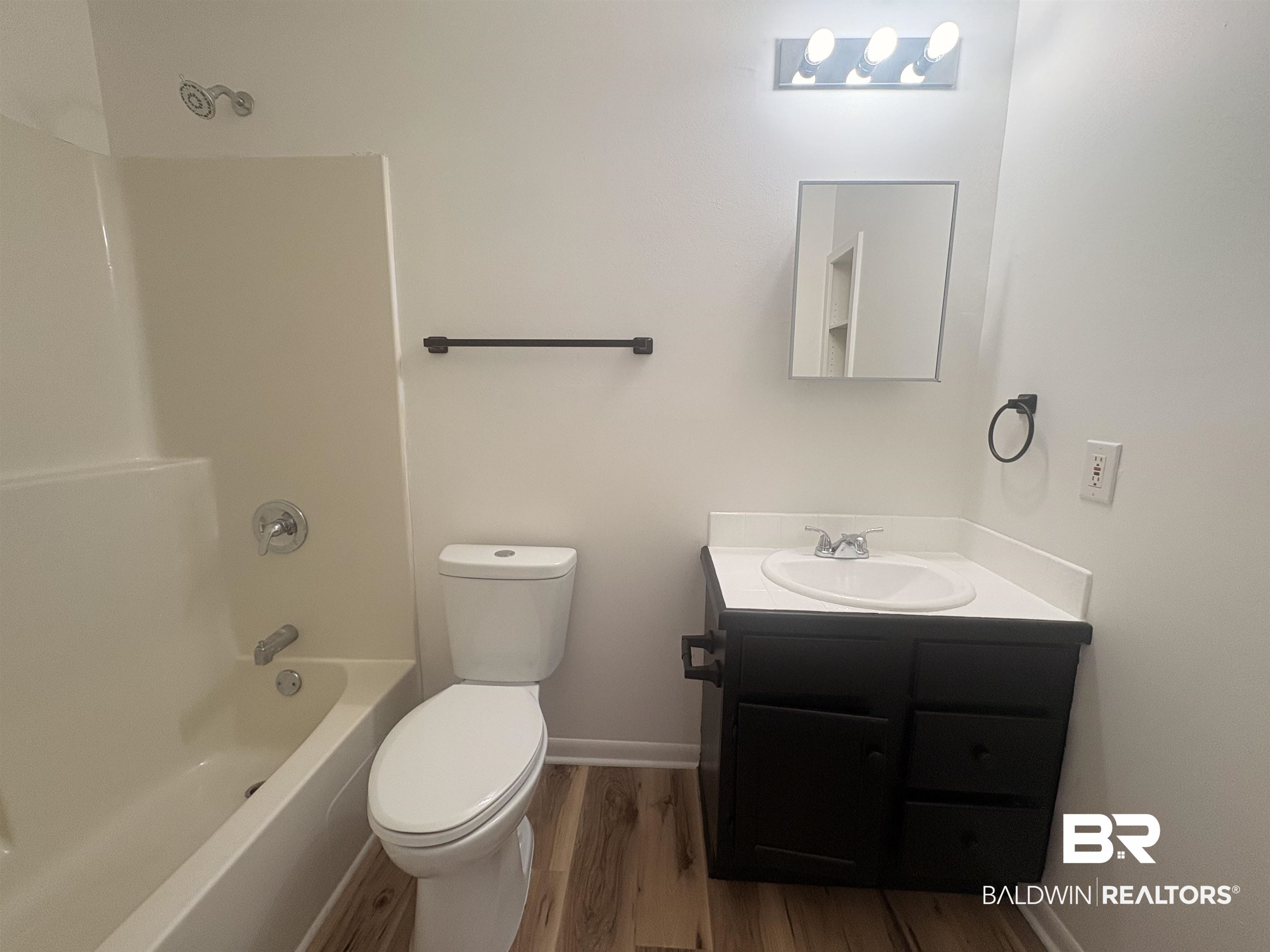 109-111 North Beech Street, Unit A & B Foley, AL 36535 - Photo 8 of 16 Bathroom with vanity, bathing tub / shower combination, and dark wood-style flooring