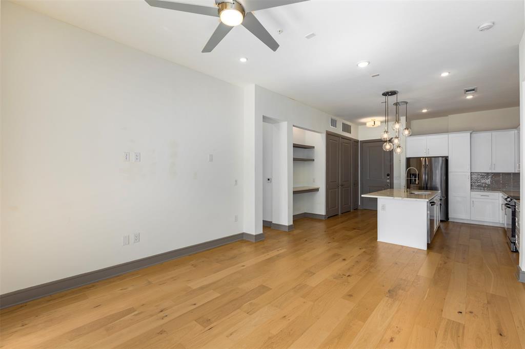 2700 Old Denton Road, Unit 1044 Carrollton, TX 75007 - Photo 5 of 33 Open-concept living space featuring wood-finish flooring, a contemporary ceiling fan, and recessed lighting