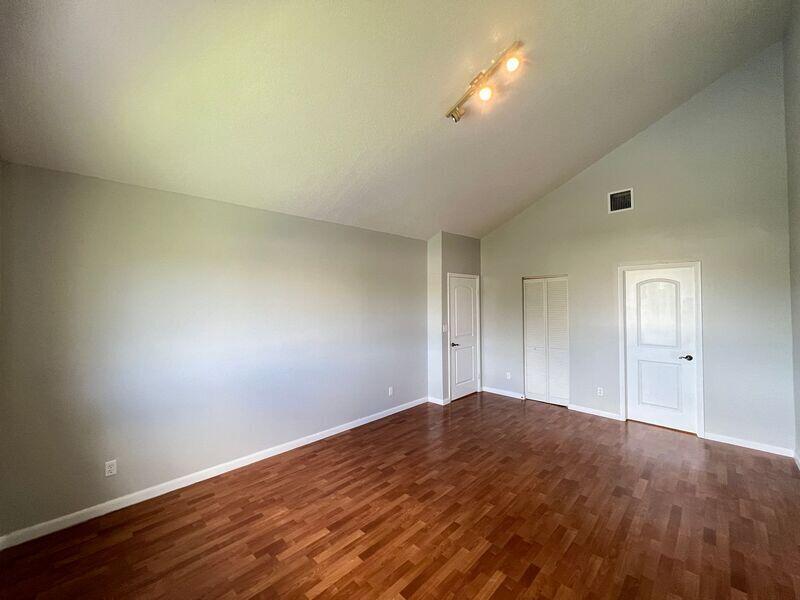 10225 Northwest 33rd Street Sunrise, FL 33351 - Photo 11 of 51 a view of empty room with wooden floor and fan