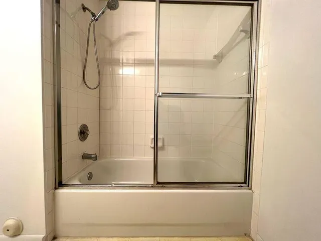 a bathroom with a bathtub and a shower
